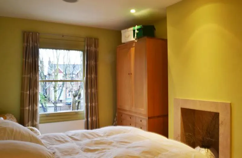 Fireplace at Bright, colourful Ealing house, B1483 (photo 32)