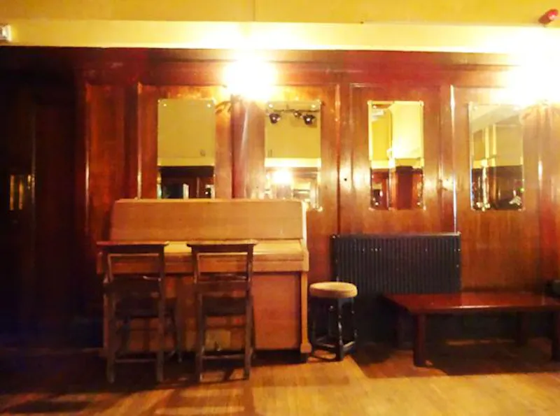 Piano at Peckham panelled pub with stage, R781 (photo 5)