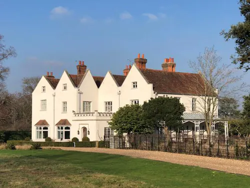 Large white grange in Cobham, A1472