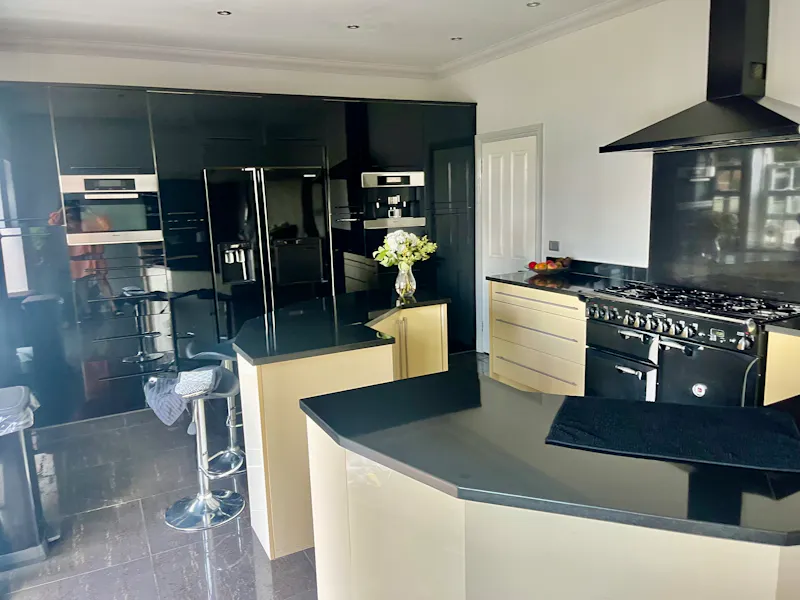 Kitchen island at Chigwell white stucco home, D2727 (photo 11)